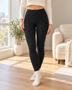 Black Everyday Fleece leggings styled at home beside a sunlit window